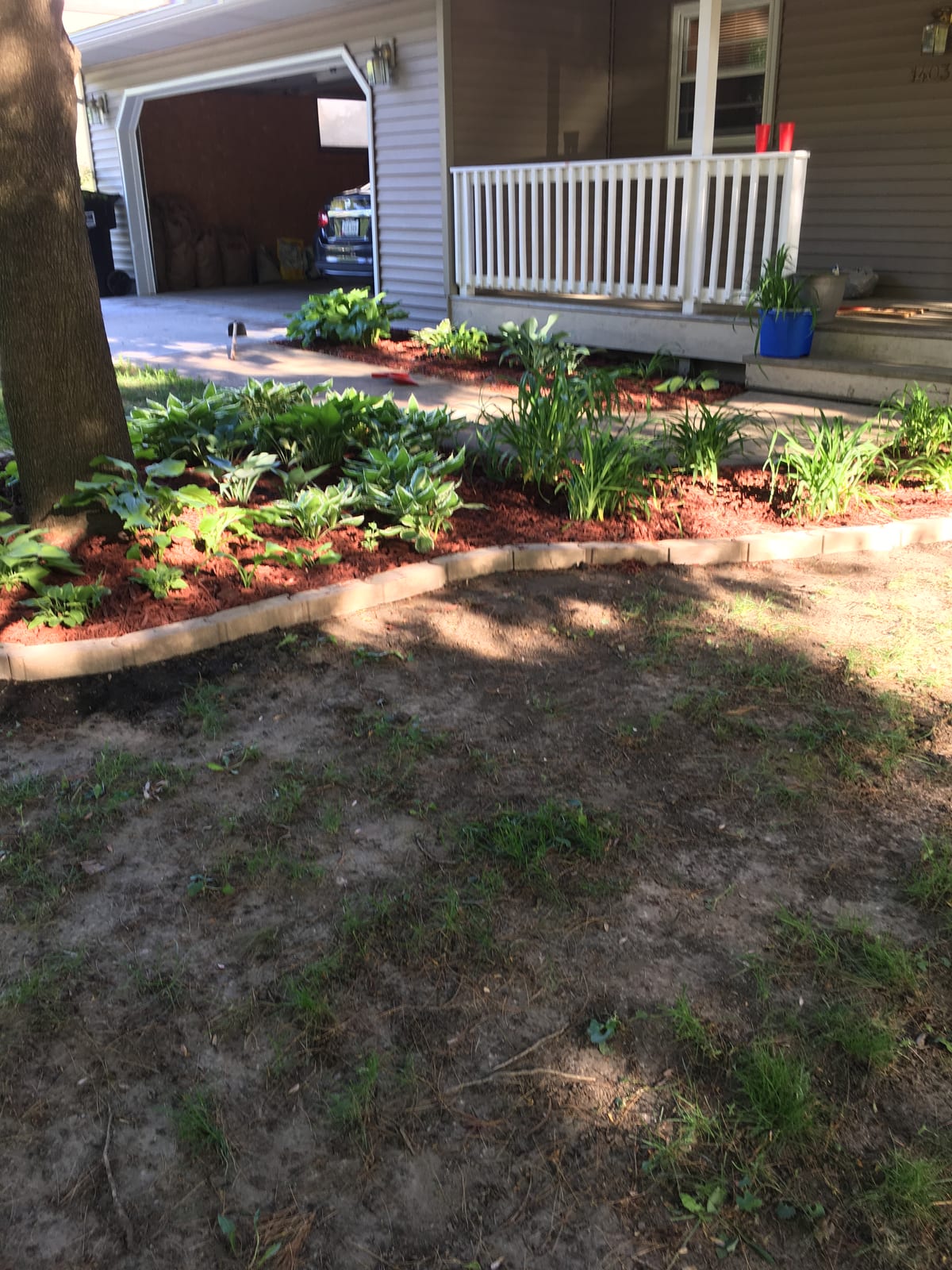 Fresh mulch and stone edging by the deck