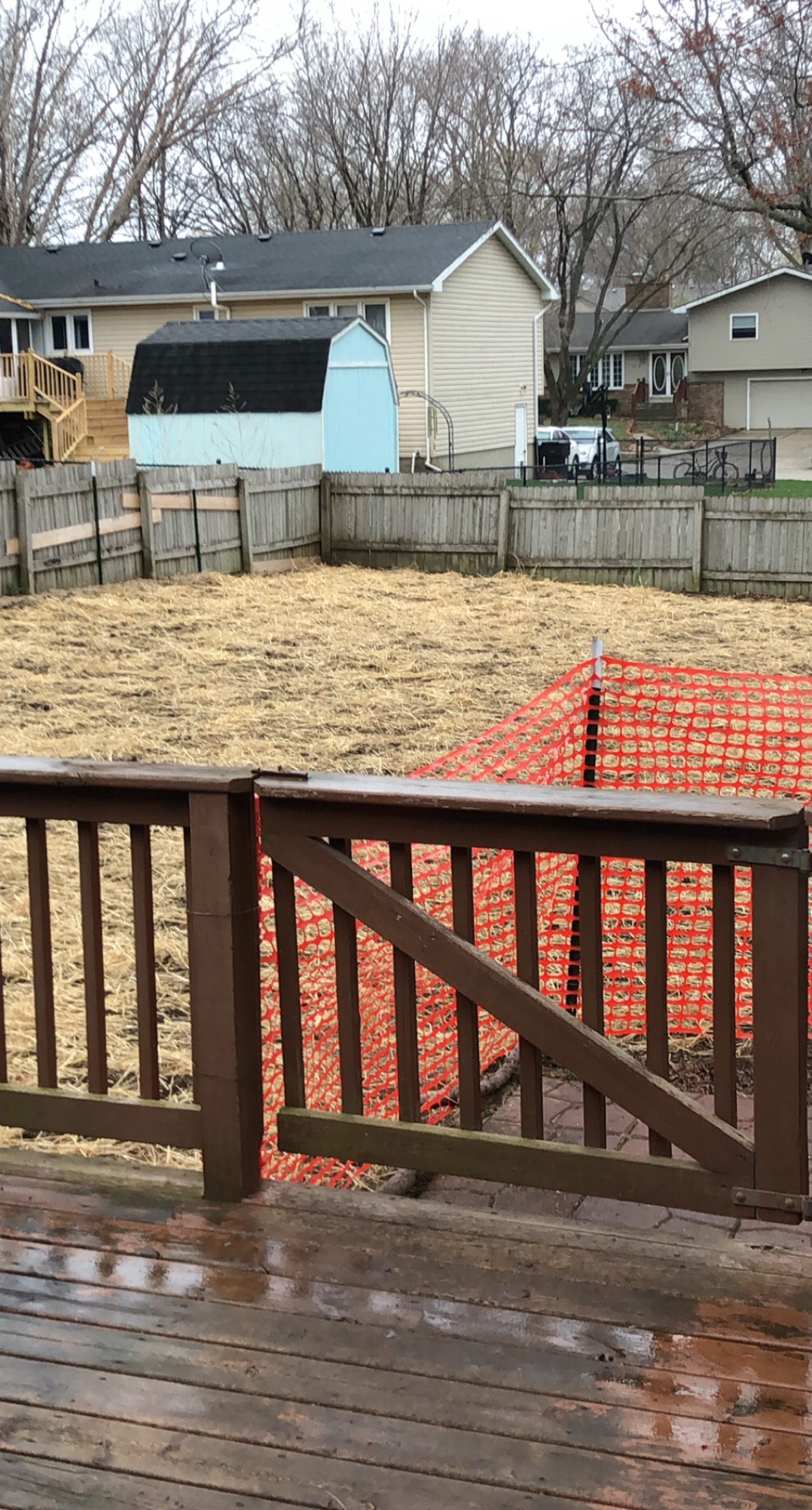 Stone fire pit ring partially dismantled in the grass