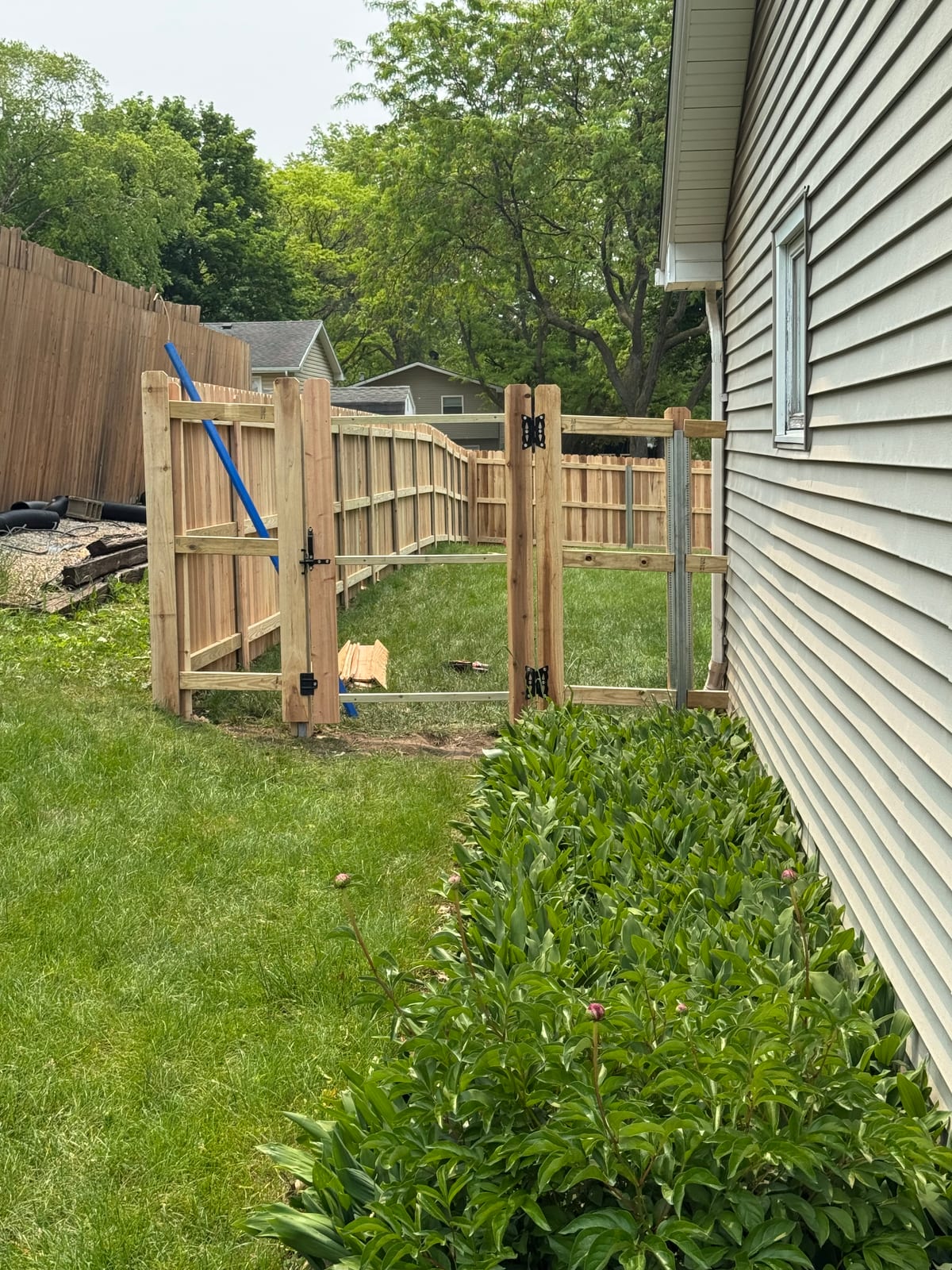 Deck framing project under construction beside the siding