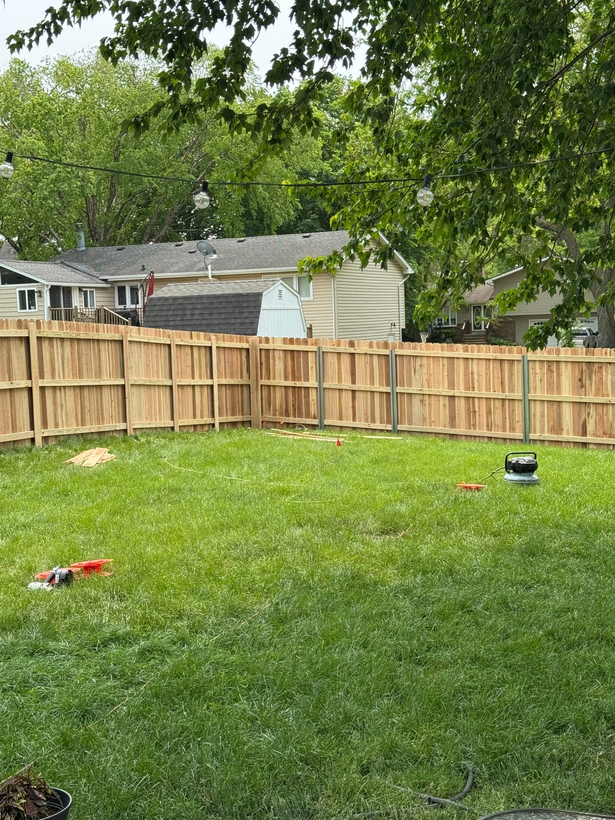 New cedar deck framing going up behind the house