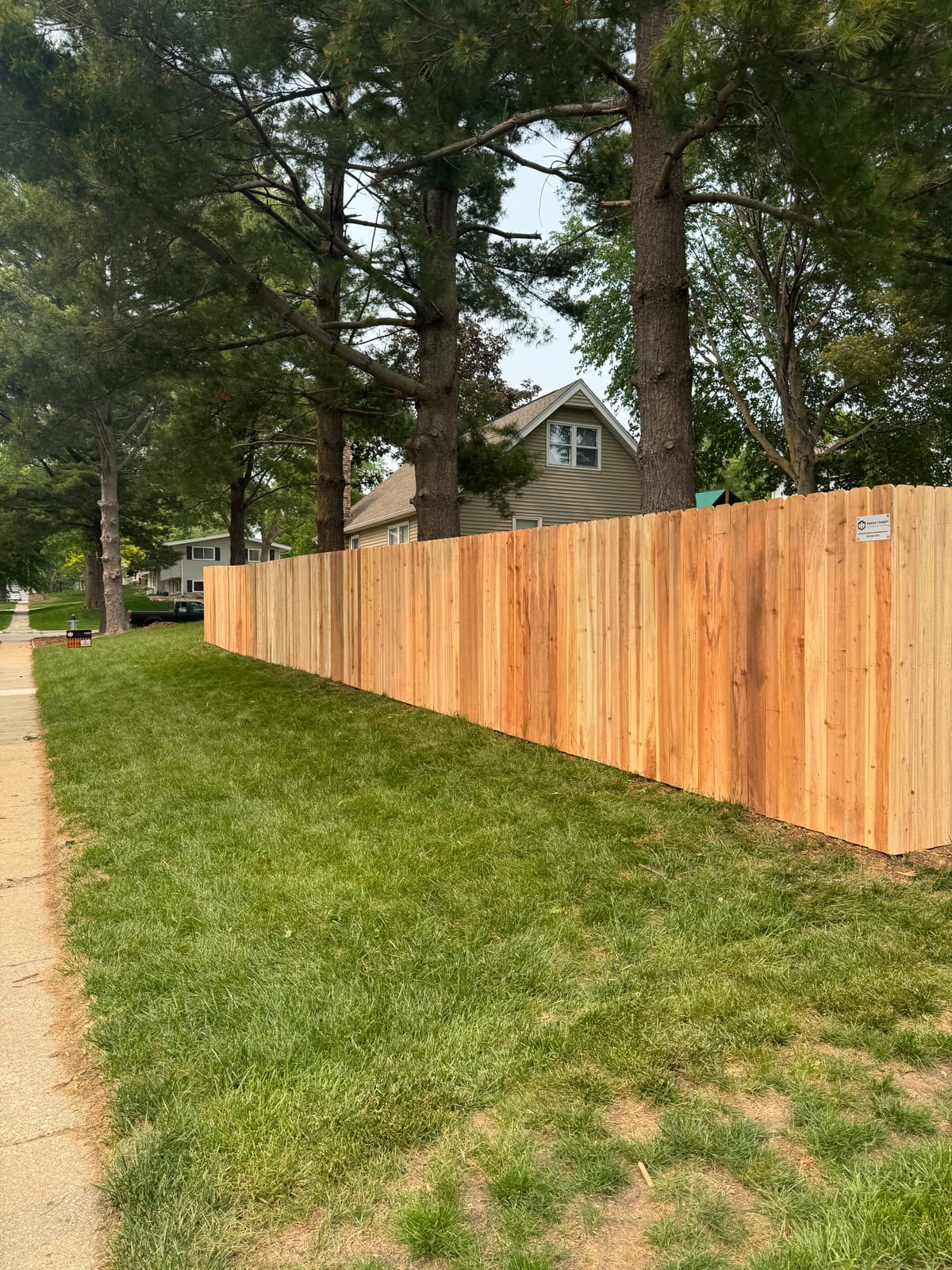 Wide cedar deck stretching across the backyard